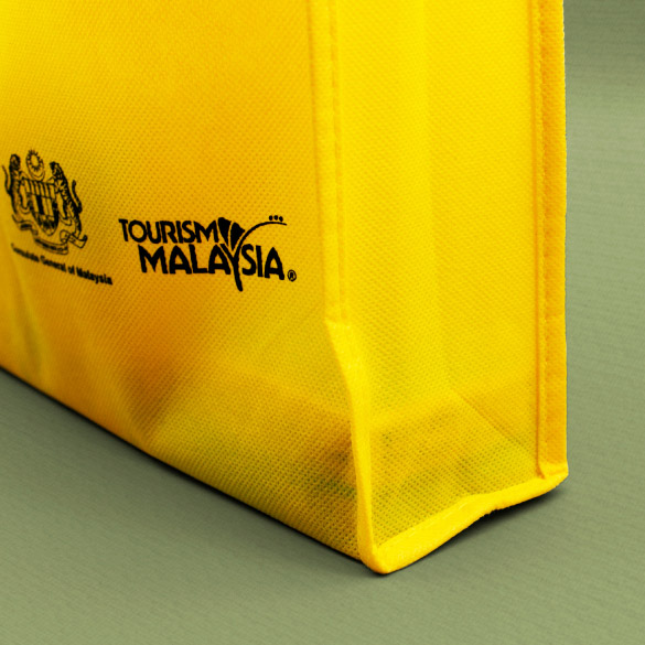 Yellow non-woven fabric bags available in both stock and customizable options.